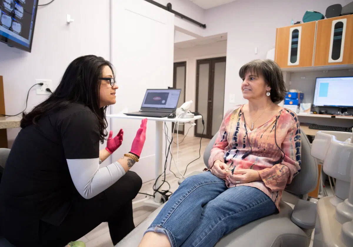 preventative-dentistry-patient-consultation-center-for-complete-healthy-dentistry-wilton-ct Dental hygienist explaining preventative dentistry care to a patient during a consultation at The Center for Complete Healthy Dentistry in Wilton, CT